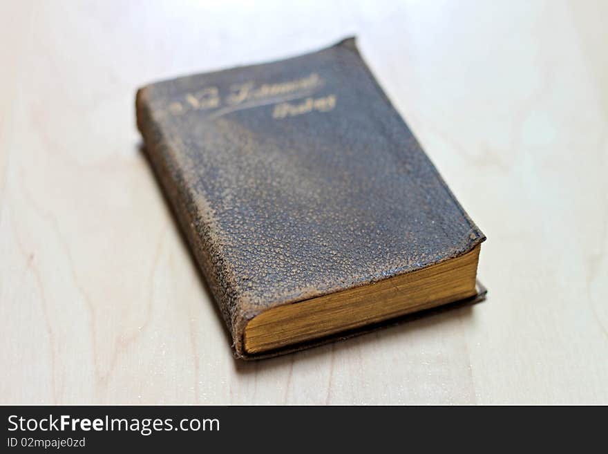 Stack of dusty worn books on poetry and and a bible