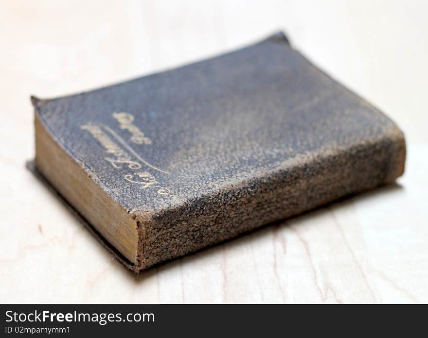 Stack of dusty worn books on poetry and and a bible