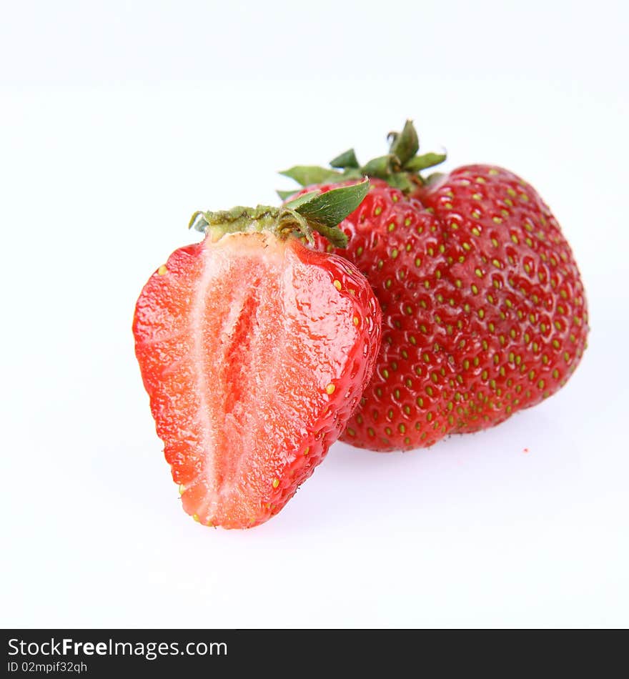 Strawberries on white background (a whole one and a half)