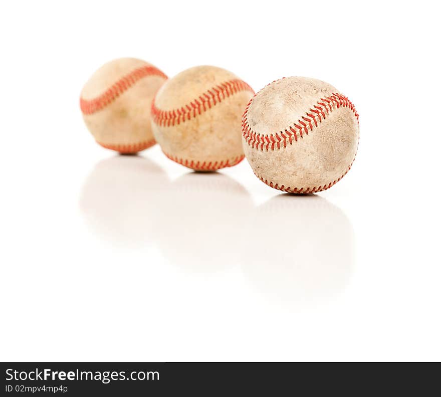 Three Baseballs Isolated on Reflective White