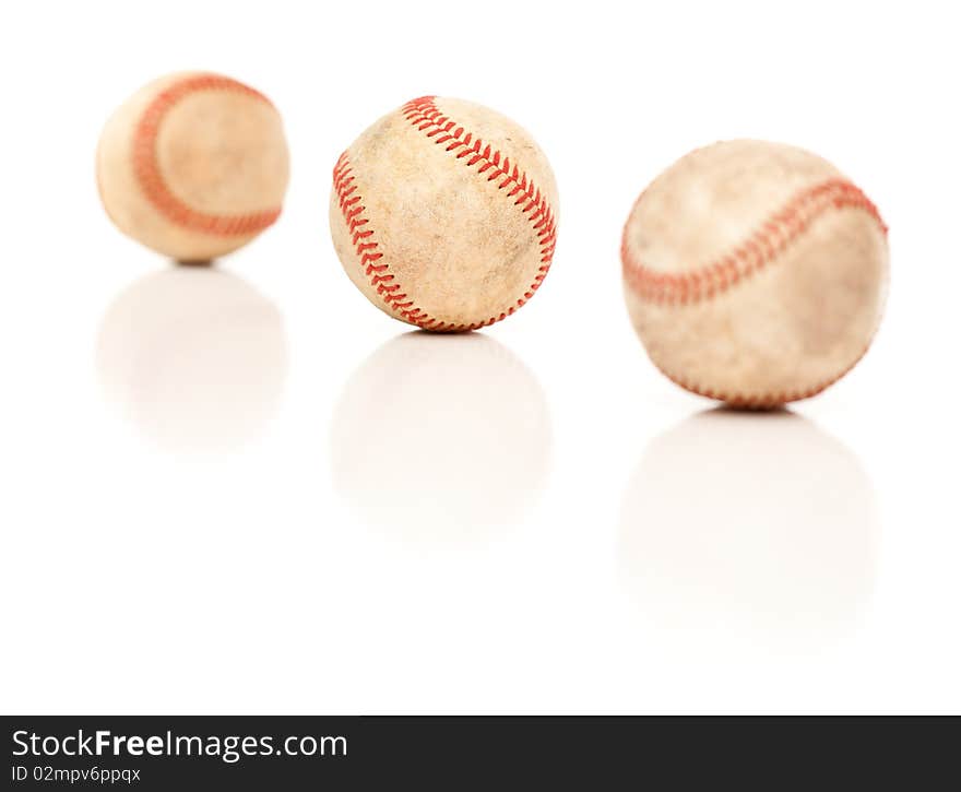 Three Baseballs Isolated on Reflective White