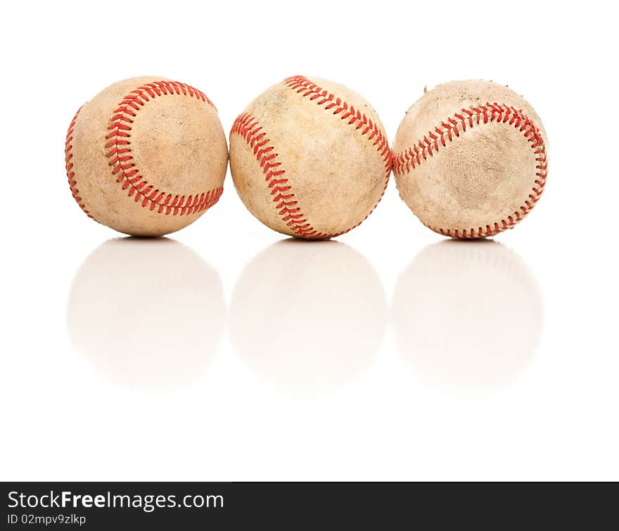 Three Baseballs Isolated on a Reflective White Background. Three Baseballs Isolated on a Reflective White Background.