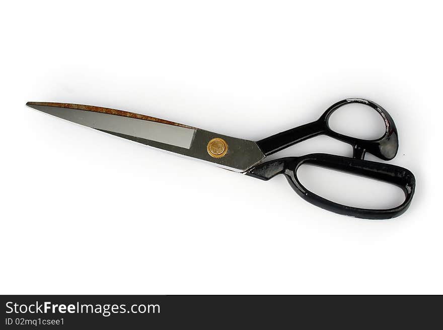 Pair of scissors over white background