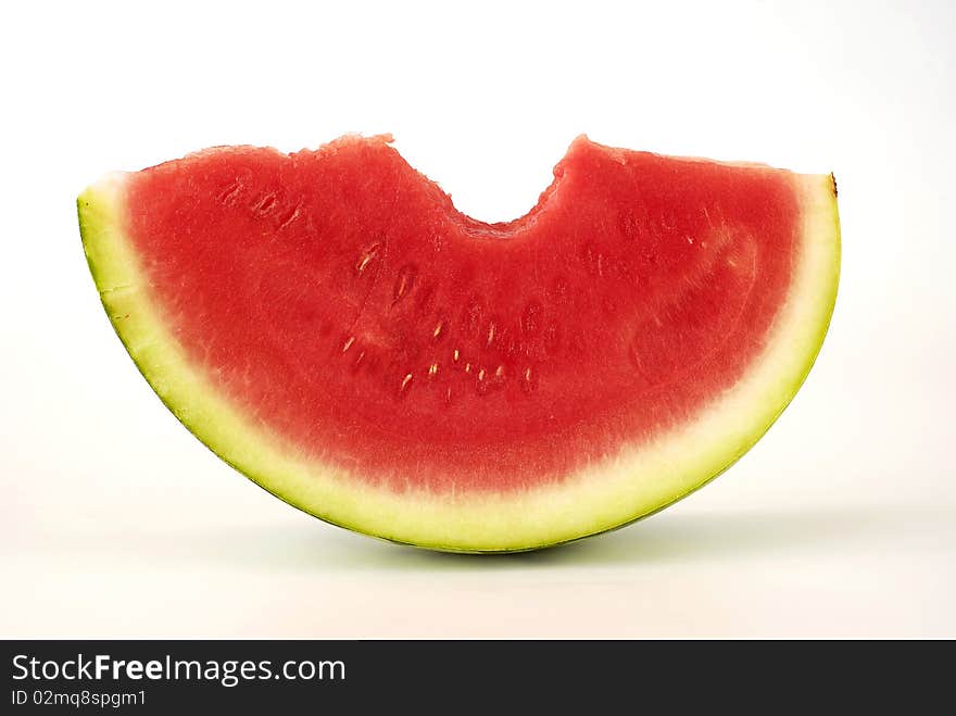 Bitten piece of watermelon on the white background