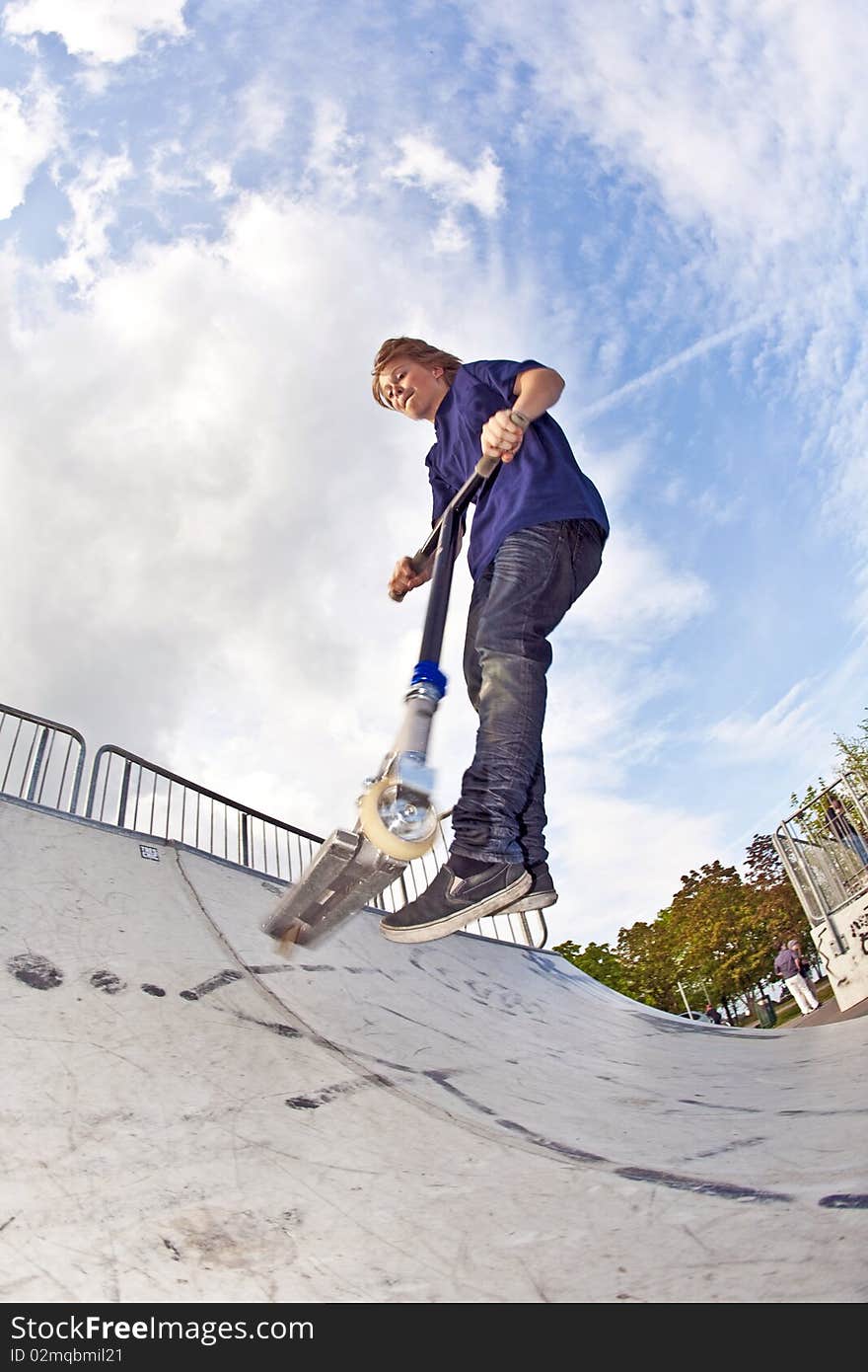 Young boy going airborne with his scooter