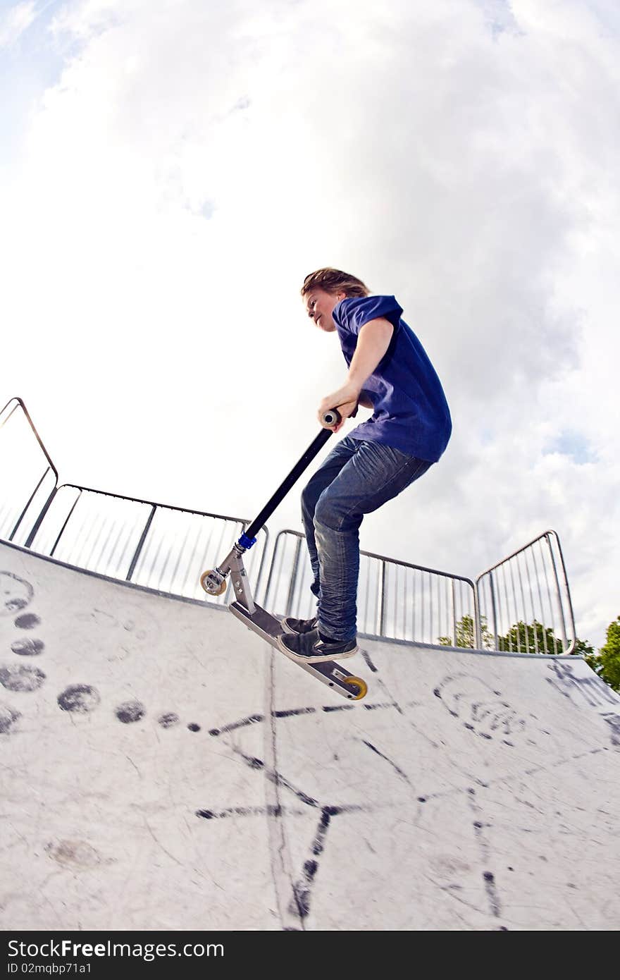 Young Boy Going Airborne With Scooter