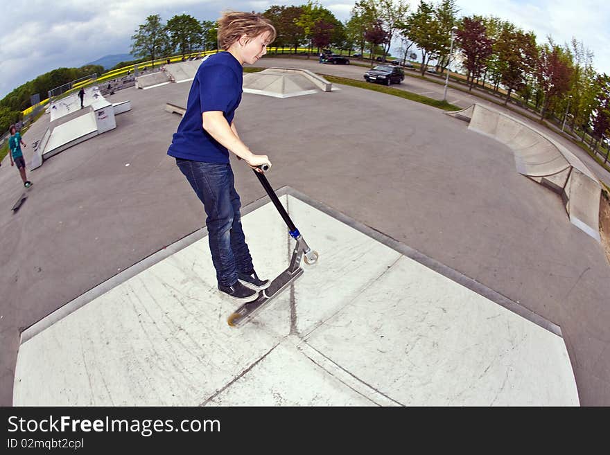 Young boy going airborne with his scooter