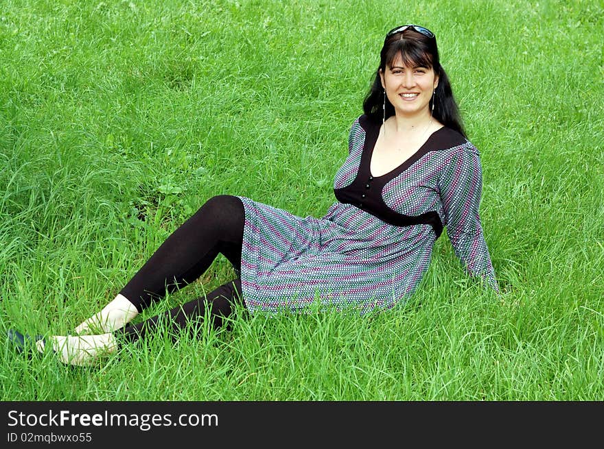 Beautiful woman relaxing in the grass