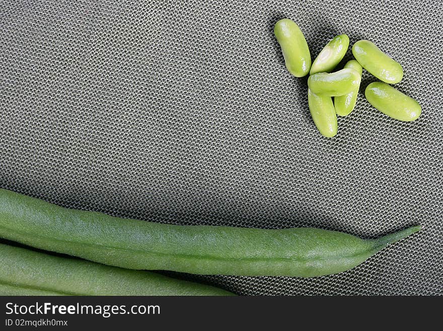 Fruits asparagus bean beans against a grey napkin.