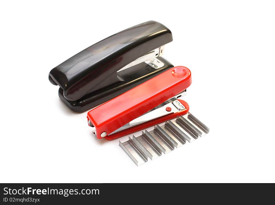 Isolated big black stapler and small red stapler with staples on white background. Isolated big black stapler and small red stapler with staples on white background