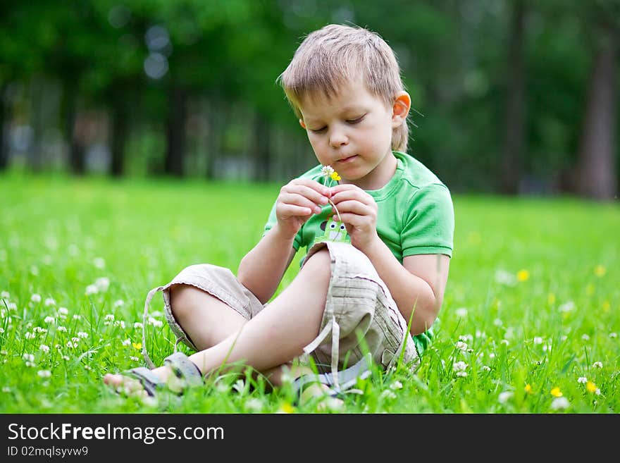 Portrait Of A Boy Smelling Flowers