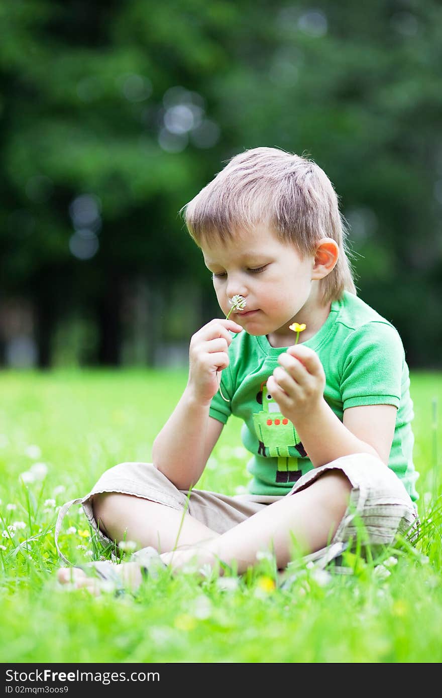 Portrait of a boy smelling flowers