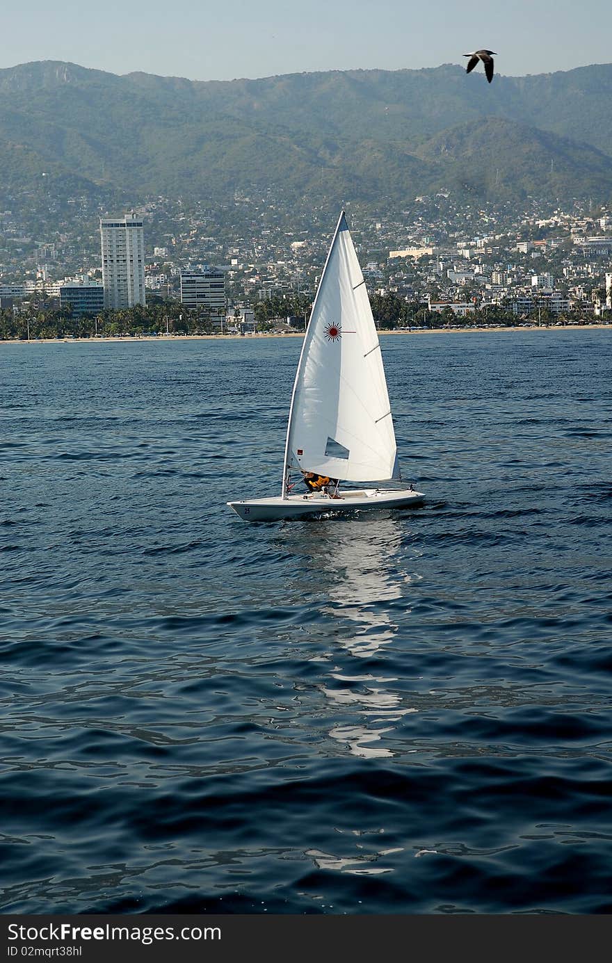 The yacht under sails floating on the sea