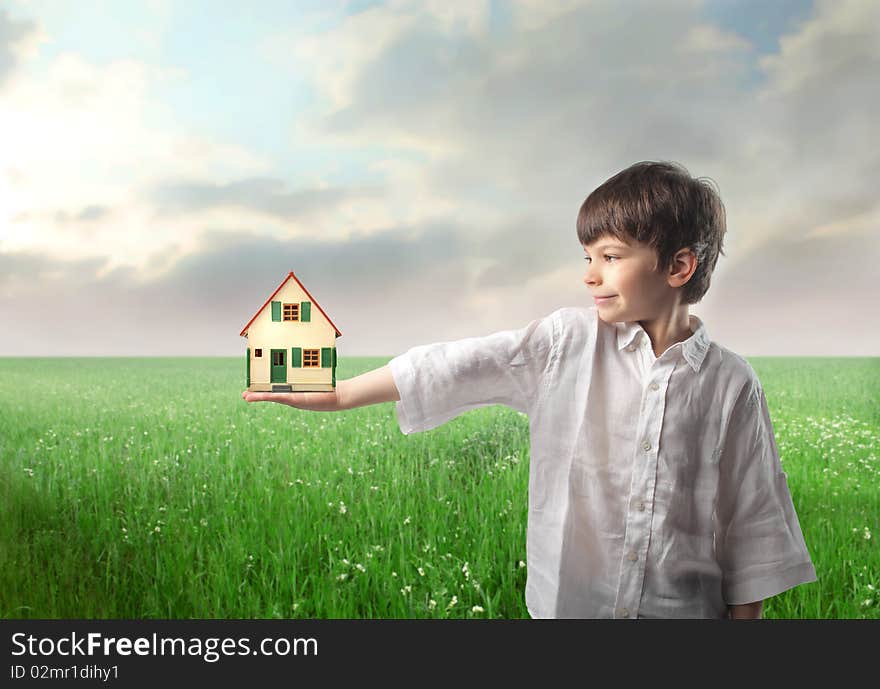 Smiling child holding the model of a house. Smiling child holding the model of a house