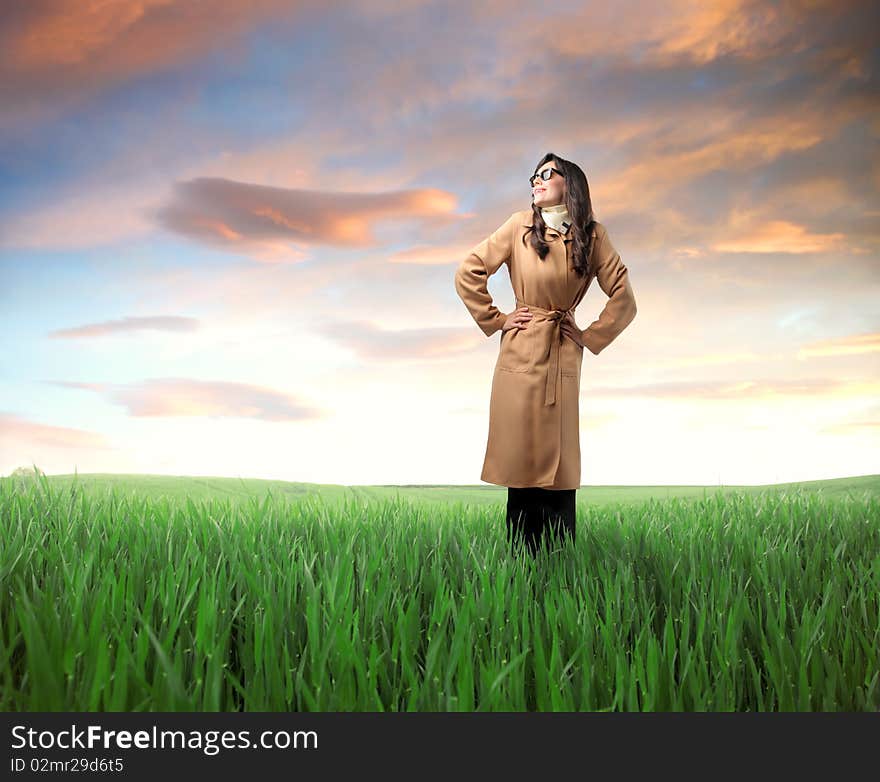 Smiling woman standing on a green meadow. Smiling woman standing on a green meadow