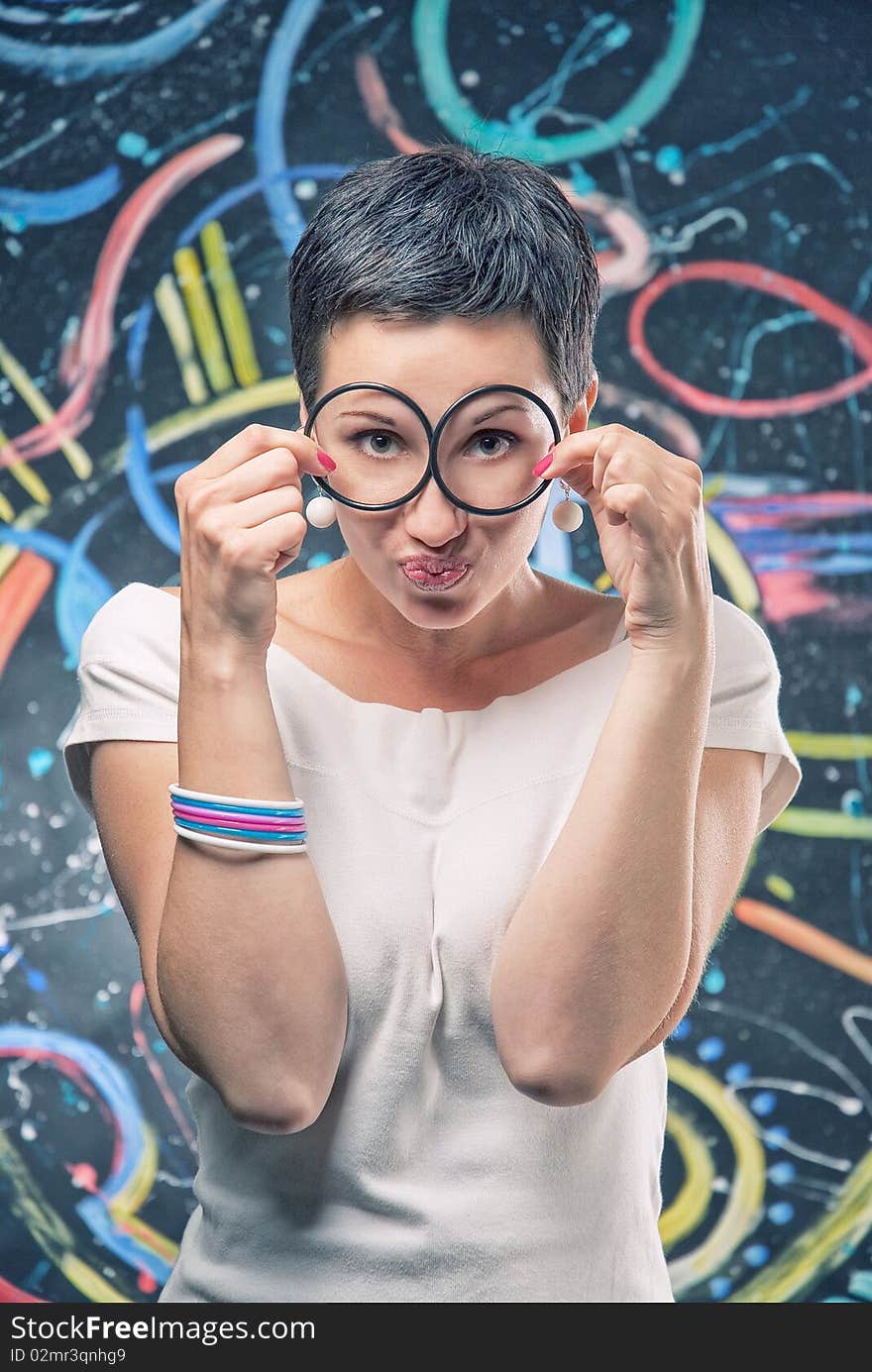 There is short hair women with two circles in her hands. There is short hair women with two circles in her hands.