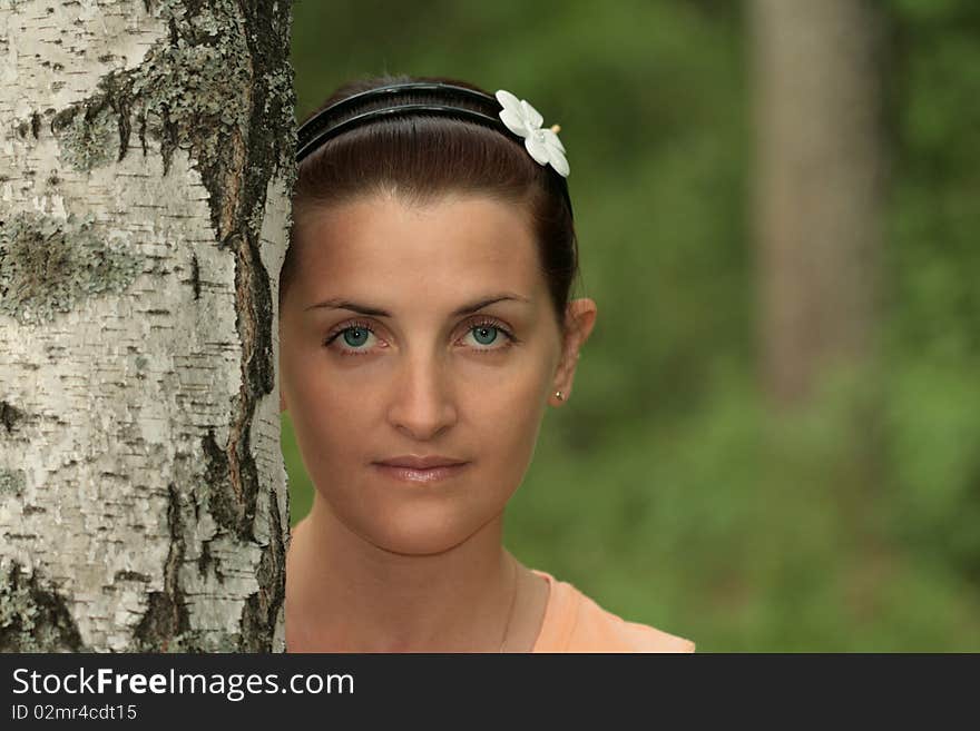 Female portrait near to a birch