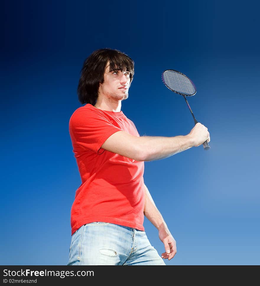 Boy with racket on blue background