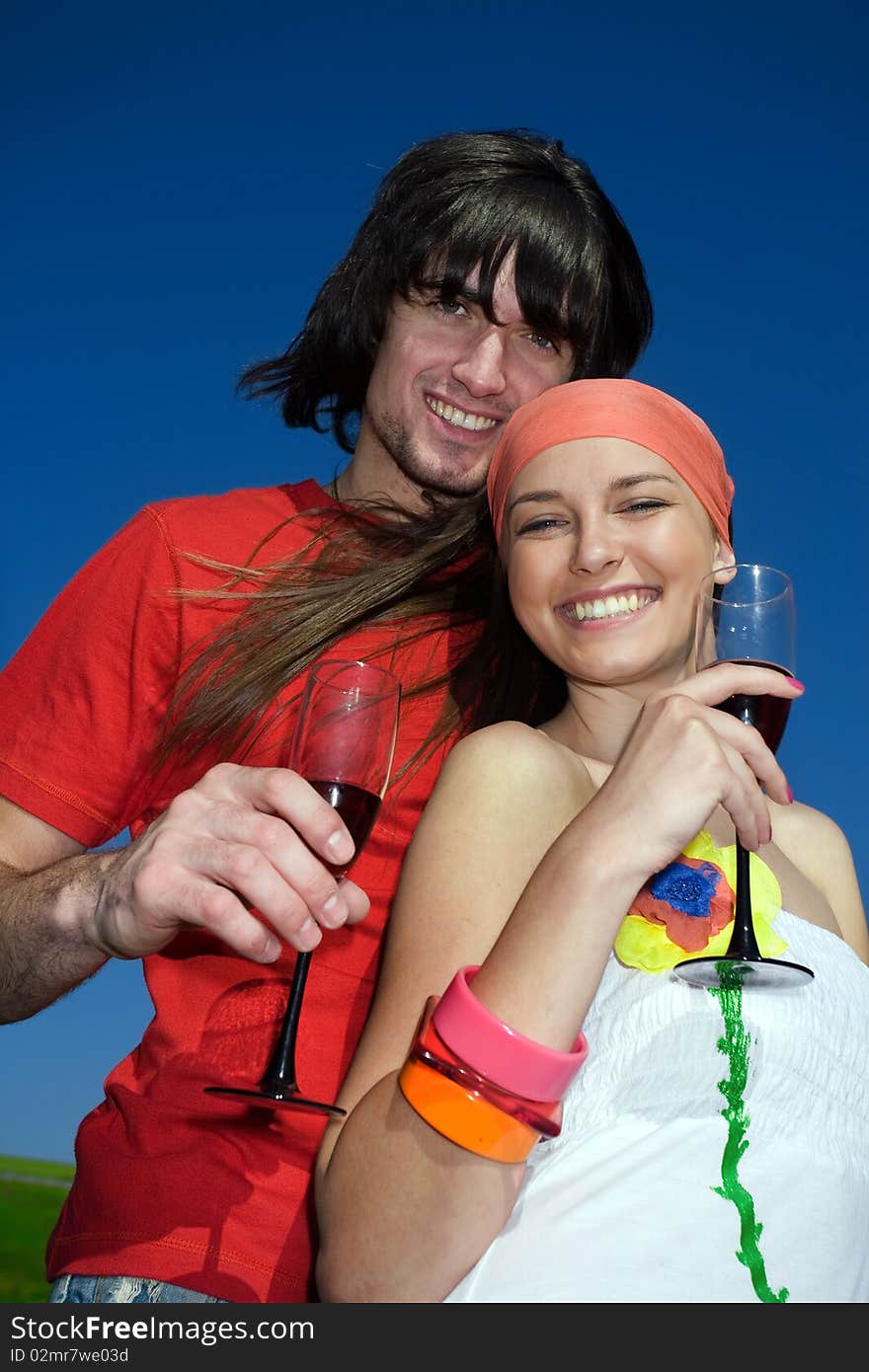 Smiling girl and boy with wineglasses