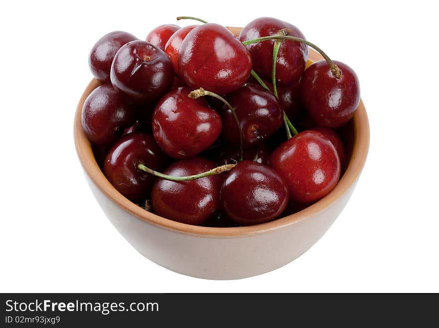 Ripe sweet cherry in a plate it is isolated on a white background