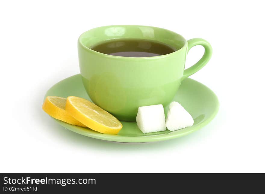 Cup of tea with lemons and lumps of sugar