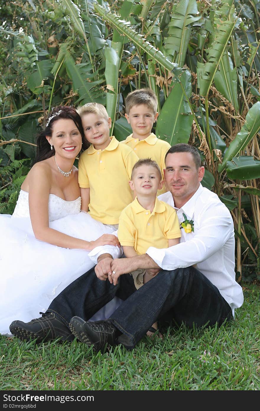 Happy gorgeous bride, husband and children