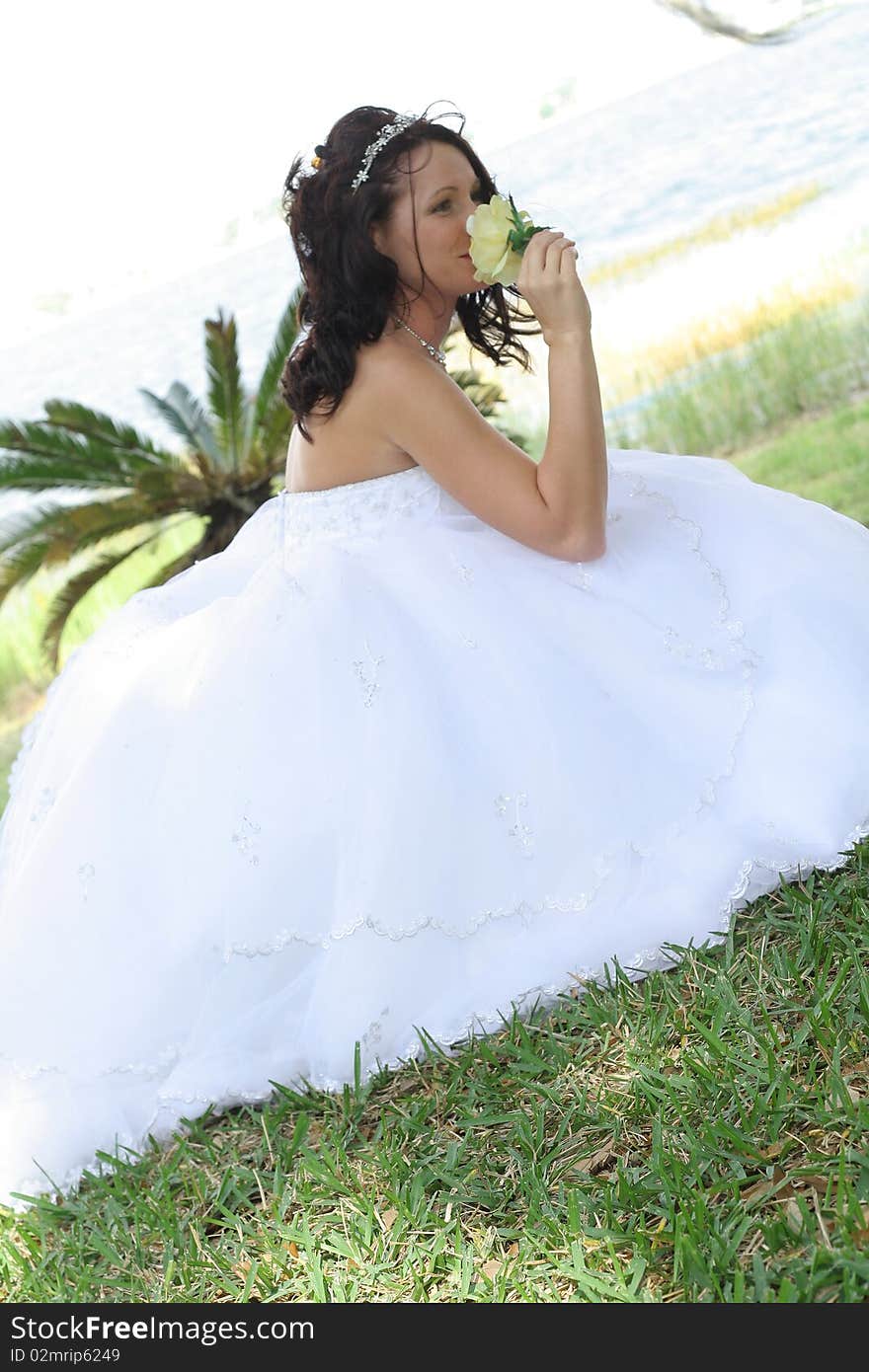 Beautiful bride smelling a flower