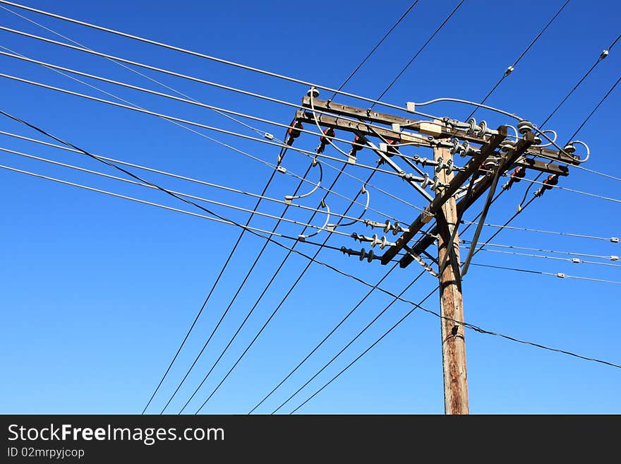 Old wooden electric pole with cables