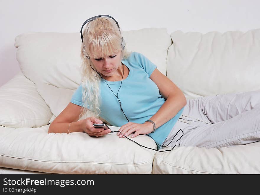 Blond Woman Listening To Her Player