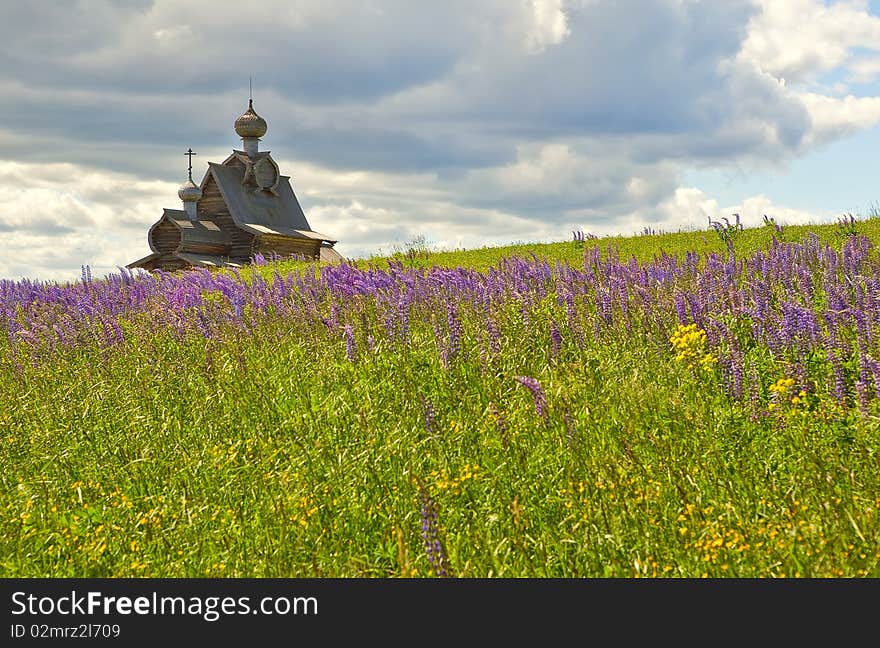 Orthodox wooden church at meadow