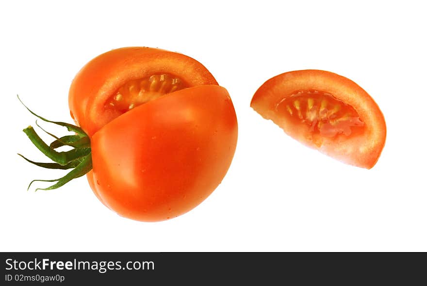 Cut red tomato with a piece on a white background