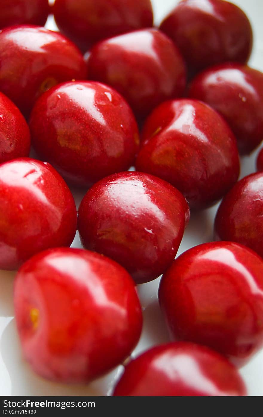 Some ripen red cherries in row