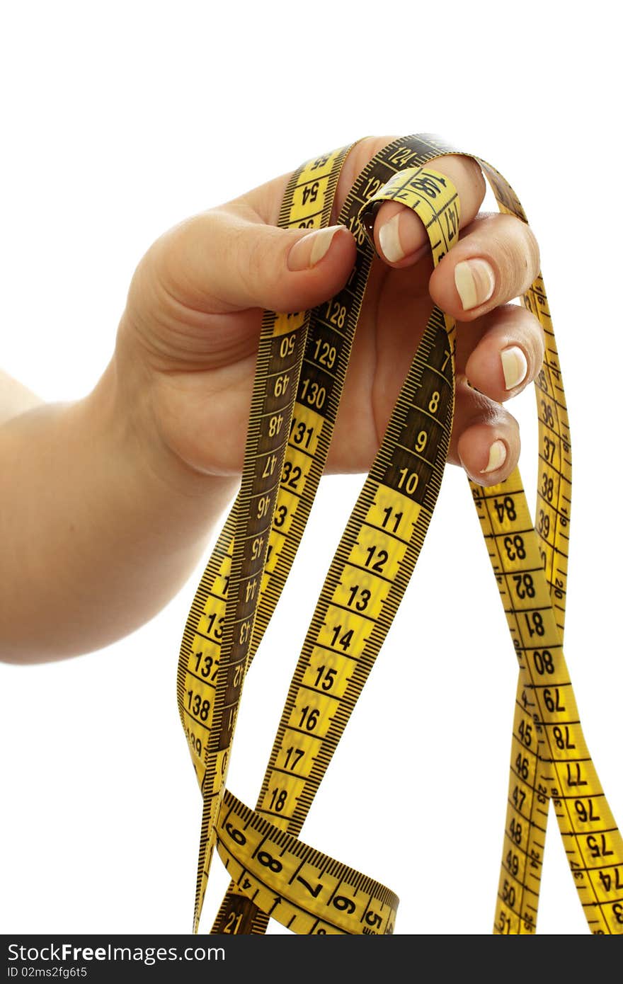 Tape measure in a beautiful female hand isolated on white background