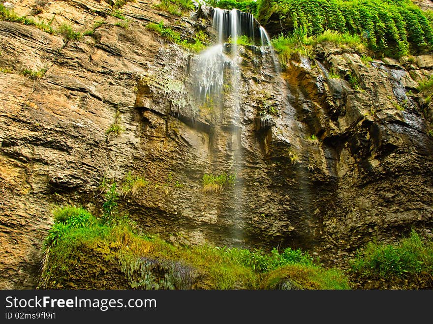 Beautiful summer waterfall at rocky mountain