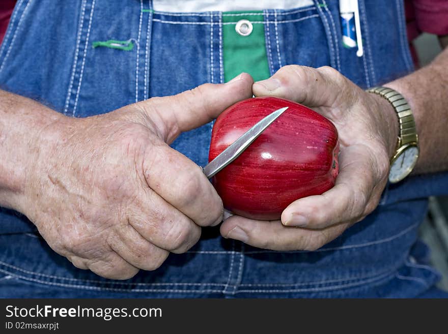 Man Cuttine A Red Apple