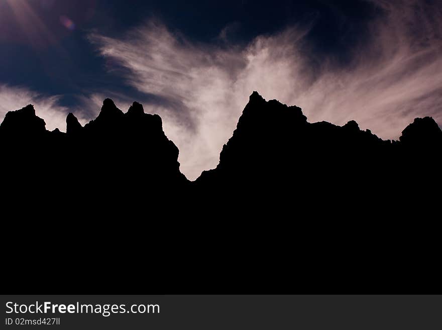 Sunset silhouette in the desert, formed by mountains. Sunset silhouette in the desert, formed by mountains