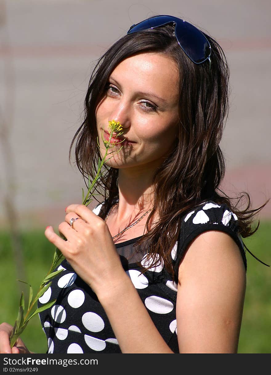 Beauty brunette girl with small yelloy flower