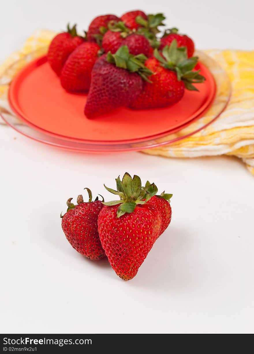 Plate of strawberries with three on white. Plate of strawberries with three on white