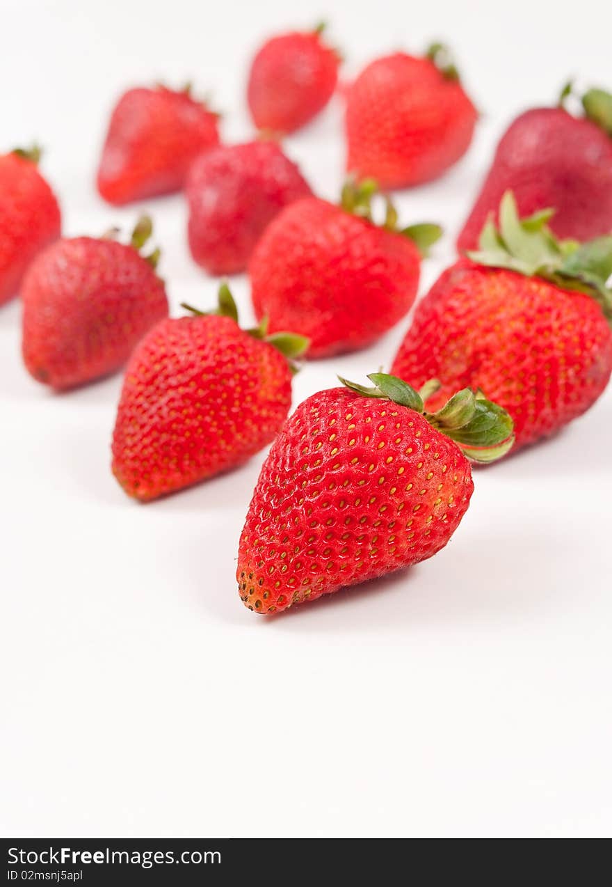 Fresh strawberries in rows on white. Fresh strawberries in rows on white