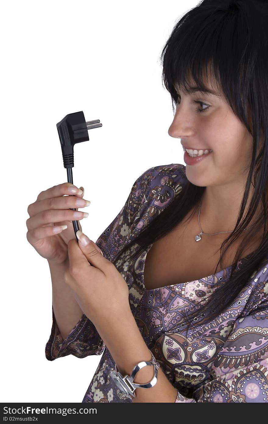 Young woman looking at the power plug and looks confused. Isolated on white. Side view.