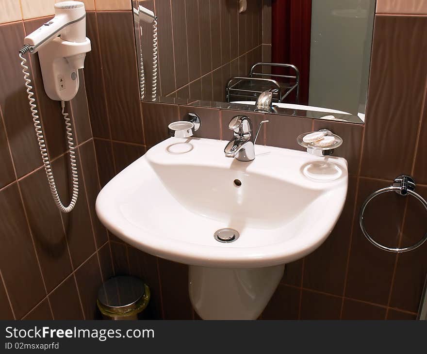 Close up of the white sink in a modern bathroom.