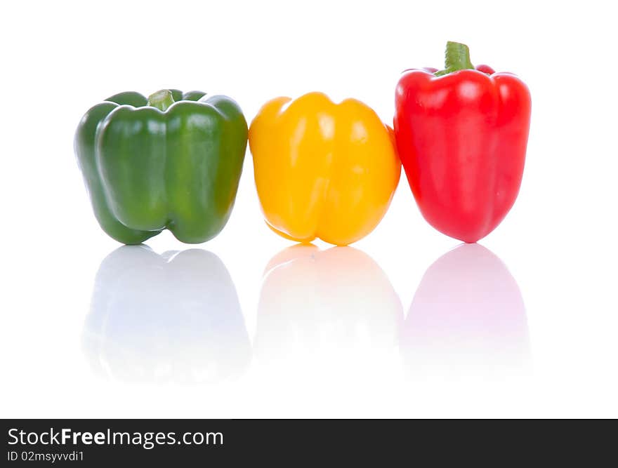 Photograph showing yellow,green and red peppers isolated