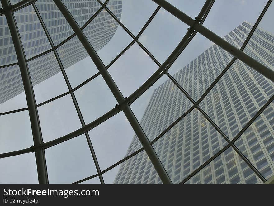 View on skyscrapers through glass roof. View on skyscrapers through glass roof.