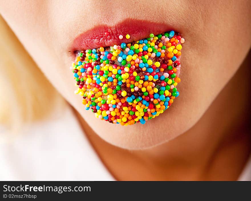 Many color bright candies on female tongue. Many color bright candies on female tongue