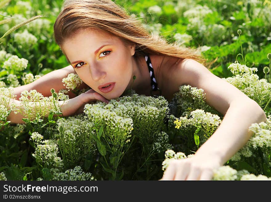 Young beautiful woman with bright makeup and white flowers. Young beautiful woman with bright makeup and white flowers