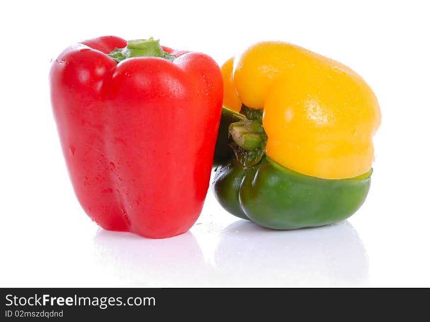 Photograph showing yellow,green and red peppers isolated