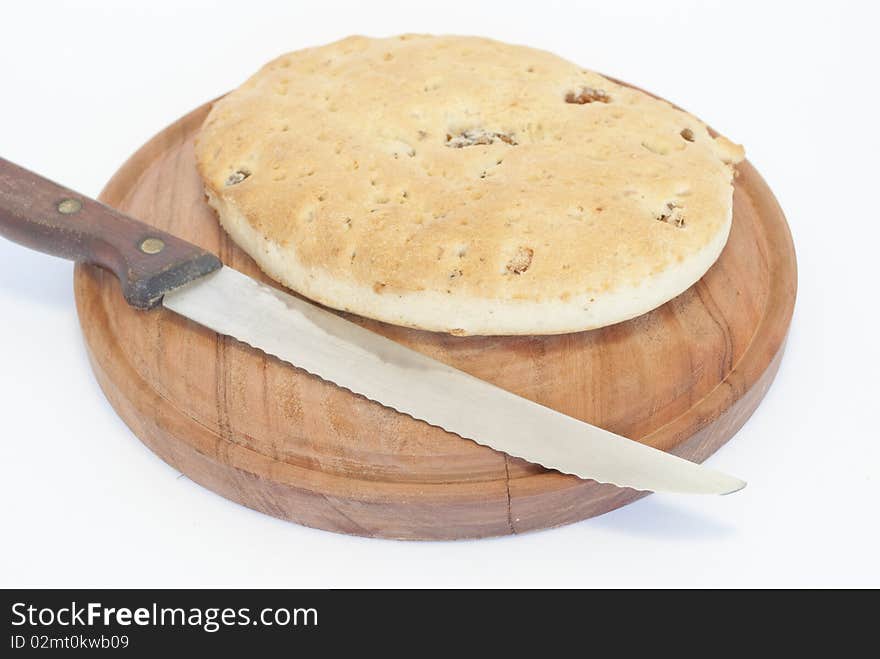 Wooden plate with bread and knife pigskin. Wooden plate with bread and knife pigskin