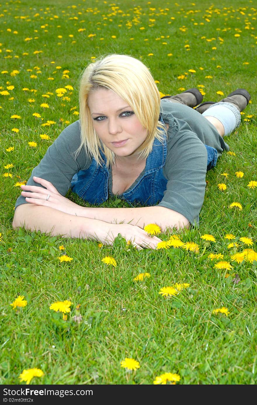 Photograph showing pretty blond girl lay in feild. Photograph showing pretty blond girl lay in feild