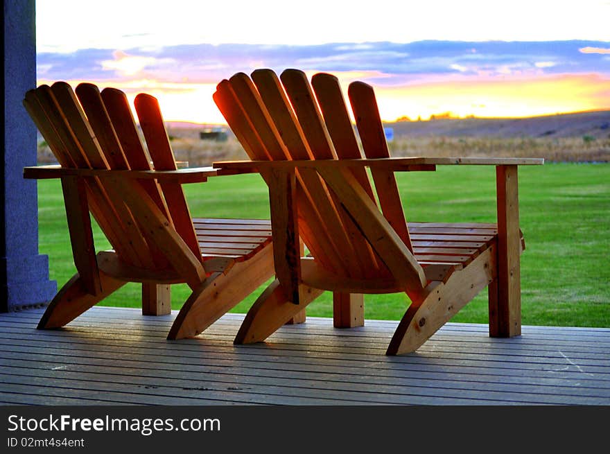 Two wood chairs at sunset