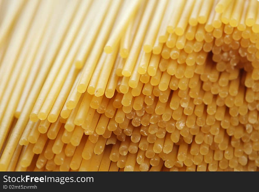 Stack of raw spaghetti noddles closeup